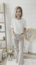 Load and play video in Gallery viewer, Leopard Print Raw Hem High Rise Flare Jeans
